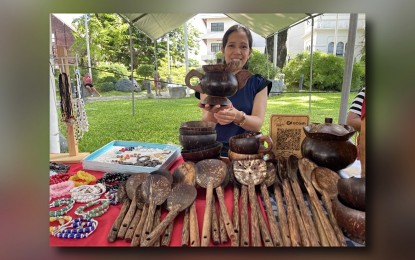 <p><strong>TRADE FAIR</strong>. Juvelyn Crusina sells coco shell crafts at the “Kadiwa ng Pangulo” in front of the Ilocos Norte capitol on June 14, 2024. She is among the active local partners of the Producer-to-Consumer program being implemented in in Metro Manila, a place for manufacturers or farmers to directly sell their products and food items like the Kadiwa program. <em>(PNA photo by Leilanie Adriano)</em></p>