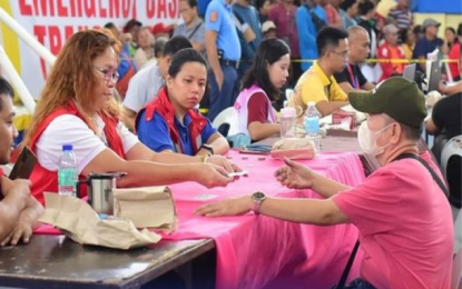 <p><strong>SHEARLINE VICTIMS.</strong> Personnel of the Department of Social Welfare and Development (DSWD) distribute cash assistance to the victims of shearline and low pressure area in Davao region in this undated photo. The DSWD on Monday (July 8, 2024) said it has disbursed some PHP1.8 billion in emergency cash transfer for affected families in the region in the first quarter of 2024. <em>(Photo courtesy of DSWD)</em></p>