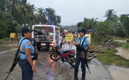 <p><strong>ON THE WATCH.</strong> Police personnel in Bindoy, Negros Oriental step up their watch after heavy rains triggered flash floods Monday afternoon (July 8, 2024). A 70-year-old man died after he was carried downstream by floodwaters while 40 families were evacuated to a safer place. <em>(Photo courtesy of Bindoy Police Station)</em></p>