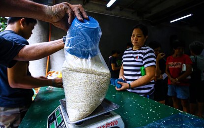 <p><strong>AFFORDABLE RICE.</strong> A customer waits for her order of PHP 29/kg rice at the National Irrigation Administration in Quezon City on July 5, 2024. Agriculture Assistant Secretary Genevieve-Velicaria Guevarra said on Friday (July 12, 2024) that they will soon launch the Rice for All program to benefit the general public with PHP45/kg. to PHP48/kg of rice.<em> (PNA photo of Joan Bondoc)</em></p>