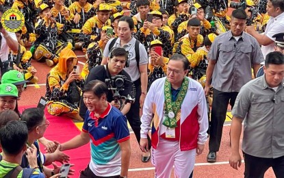 <p><strong>PALARONG PAMBANSA 2024.</strong> President Ferdinand Marcos Jr. and Cebu City Acting Mayor Raymond Alvin Garcia greet the athletes at the Cebu City Sports Center for the formal opening ceremony of Palarong Pambansa on Tuesday (July 9, 2024). Marcos, who led the ceremonial lighting of the torch, said technology and social media play a big part in generating up-to-date results.<em> (Photo courtesy of Cebu City-PIO)</em></p>