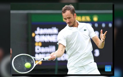 <p><strong>OFF TO SEMIS.</strong> Daniil Medvedev of Russia hits a return during the men's singles quarterfinal match of Wimbledon Championship with World Number 1 Jannik Sinner of Italy on Wednesday (July 9, 2024) in London. Medvedev will face defending champion Carlos Alcaraz of Spain.<em>(Xinhua)</em></p>