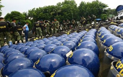 <p><strong>FULL FORCE.</strong> Quezon City Police District officers inspect their equipment at their headquarters in Camp Karingal on July 10, 2024. At least 22,000 cops will be deployed, with 6,000 in and around the Batasang Pambansa Complex, for the third State of the Nation Address of President Ferdinand R. Marcos Jr. on July 22. <em>(PNA file photo by Joan Bondoc)</em></p>