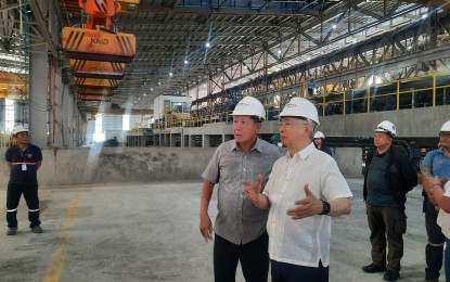 <p><strong>ROADMAP</strong>. Trade Secretary Secretary Alfredo Pascual (wearing white) talks to SteelAsia chairman and chief executive officer Benjamin Yao in a plan visit at SteelAsia Compostela Works in Compostela, Cebu on May 23, 2024. President Ferdinand R. Marcos Jr. graced the inauguration of this facility on July 10, 2024. <em>(PNA photo by Kris M. Crismundo)</em></p>