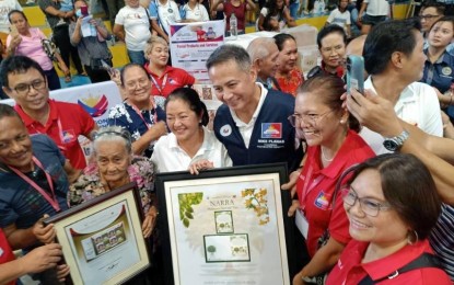 <p><strong>CENTENARIAN STAMPS</strong>. First Lady Liza Araneta-Marcos joins a LAB for ALL Service Caravan in this undated photo. Accompanied by Postmaster General Mike Planas, the First Lady awarded the Centenarian Personalized Stamps to Basilia Tabudlong Ortiz of Mandaluyong City and Ceasario Gubaton Lamela Jr. of Bacolod City. <em>(PHLPost photo)</em></p>