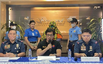 <p><strong>NABBED.</strong> Interior Secretary Benjamin Abalos Jr. (seated, center) and Philippine National Police Chief Gen. Rommel Marbil (right) present to the media Pauleen Canada (standing, center), one of the co-accused of Kingdom of Jesus Christ leader Pastor Apollo Quiboloy on human trafficking charges, in a press briefing in Camp Crame on Friday (July 12, 2024). Canada, who has a PHP1 million bounty for her arrest, was nabbed in Davao City on Thursday (July 11, 2024). <em>(PNA photo by Lloyd Caliwan)</em></p>