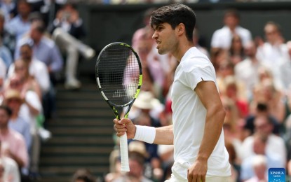 <p><strong>STILL CHAMP.</strong> Carlos Alcaraz of Spain celebrates after scoring during the men's singles final between him and Novak Djokovic of Serbia at Wimbledon tennis Championship in London, Britain, July 14, 2024. Alcaraz defeated Djokovic, 6-2, 6-2, 7-6(4). <em>(Xinhua/Han Yan)</em></p>