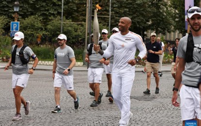 <p><strong>TORCH RELAY.</strong> French football Olympics 2024 coach Thierry Henry (center) holds the Olympic torch during the Olympic Games Paris 2024 Torch Relay in Paris, France, Sunday (July 14, 2024). The Olympics will be held from July 26 to Aug. 11. <em>(Xinhua/Gao Jing)</em></p>