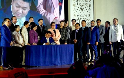 <p><strong>NOW ONLINE.</strong> Bureau of Customs Commissioner Bienvenido Rubio (seated) signs the Customs memorandum order on the procedure in the implementation of the ATA Carnet system in the Philippines on Monday (July 15, 2024) in Ermita, Manila. As the Philippines now uses the “passport of goods”, this will allow exporters to enjoy duty- and value-added tax-free and streamlined temporary admission of goods into countries that also use the international customs document. <em>(PNA photo by Ben Briones)</em></p>