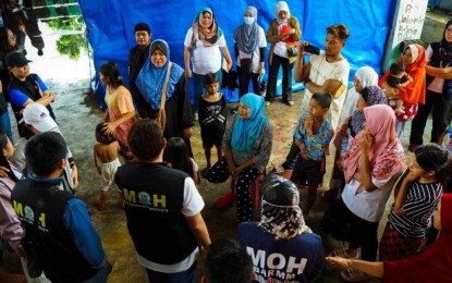 <p><strong>CODE WHITE PROTOCOL</strong>. Front-line health workers of the Bangsamoro Autonomous Region in Muslim Mindanao (BARMM) meet outside an evacuation center in Matanog, Maguindanao del Norte on Tuesday (July 16, 2024). The Ministry of Health of the Bangsamoro Autonomous Region in Muslim Mindanao (MOH-BARMM) on Wednesday (July 17, 2024) declared a code white protocol in all hospitals in flooded areas of the region for a possible spike in diseases related to floods, which has so far affected more than 120,000 people in 413 barangays. <em>(Photo courtesy of MOH-BARMM)</em></p>