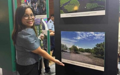 <p><strong>COASTAL PROTECTION.</strong> Negros Occidental Provincial Environment Management Office head Julie Ann Bedrio shows an image of the province’s coastal greenbelt zone, which is part of “Our Coastal Greenbelts, Our National Treasure” photo exhibition at the National Museum of Natural History in Ermita, Manila. Set from July 16 to Aug. 2, 2024, the exhibit “highlights the country’s coastal greenbelts, showcasing their pivotal role as our frontline defense against the profound impacts of climate change.” <em>(Photo courtesy of PIO Negros Occidental)</em></p>