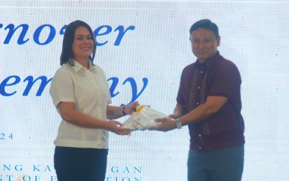 <p><strong>NO CABINET POST</strong>. Outgoing Education Secretary, Vice President Sara Duterte (left), presents the DepEd logo to incoming Secretary Juan Edgardo “Sonny” Angara during the turnover of the Department of Education's leadership held at its central office in Pasig City on Thursday (July 18, 2024). Duterte said she would no longer hold any cabinet post after resigning as education chief. <em>(PNA photo by Avito Dalan)</em></p>