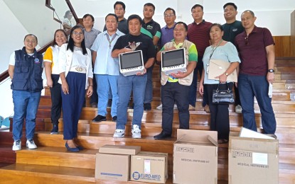 <p><strong>AID TO LGUs</strong>. Department of Health-Cordillera Administrative Region (DOH-CAR) Regional Director Dr. Ferdinand Benbenen (4th from left) turns over medical supplies and equipment like cardiac monitor units to Apayao Governor Elias Bulut Jr. (front row, middle) in a simple activity at the Apayao Provincial Capitol in Luna, Apayao on Thursday (July 18, 2024). At least 127,000 residents of the province are expected to benefit from the services and supplies that continue to be provided by the DOH. <em>(PNA photo by Liza T. Agoot)</em></p>