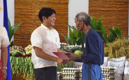 <p><strong>CONDONATION</strong>. President Ferdinand R. Marcos Jr. (left) gives a Certificates of Condonation with Release of Mortgage to Ramon Zaratan in Lingayen, Pangasinan on Friday (July 19, 2024). According to the Presidential Communications Office, over 138,000 agrarian reform beneficiaries have so far received land titles since July 2022 under the Marcos administration. <em>(Photo courtesy of PIA-Pangasinan)</em></p>