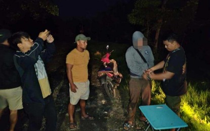 <p><strong>BUSTED.</strong> Police operatives arrest a suspected drug pusher (in gray hoodie) during a buy-bust in Barangay Cangmating, Sibulan, Negros Oriental close to midnight Friday (July 19, 2024). Seized from him was suspected shabu with an estimated street value of PHP2.87 million. <em>(Photo courtesy of the Negros Oriental Police Provincial Office)</em></p>