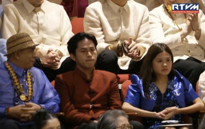 <p style="text-align: left;"><strong>TOPNOTCHERS</strong>. President Ferdinand R. Marcos Jr. acknowledges Teacher Khane Jevie Cervantes (right) and Engr. Alexis Alegado (middle), two of the 35 board exams topnotchers in the past two years who were former monitored children of the Pantawid Pamilyang Pilipino Program (4Ps), during his third State of the Nation Address (SONA) on Monday (July 22, 2024). According to the President, 420,000 families have graduated from the program since his last SONA in 2023. <em>(RTVM Screengrab)</em></p>