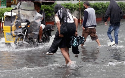 <p><strong>DRENCHED.</strong> Motorists and pedestrians are stranded due to a gutter-deep flood along the corner of Taft and UN Avenues in Manila following a heavy downpour on Tuesday (July 23, 2024). The Department of Health on Wednesday (July 24) declared a Code White alert due to continuous heavy rain showers and floods brought by Typhoon Carina and the enhanced southwest monsoon. <em>(PNA photo by Yancy Lim)</em></p>