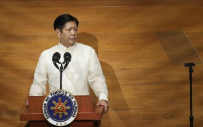 <p><strong>STEADY PROGRESS.</strong> President Ferdinand R. Marcos Jr. delivers his third State of the Nation Address at Batasang Pambansa in Quezon City on Monday (July 22, 2024), with Senate President Francis Escudero (left) and House of Representatives Speaker Martin Romualdez on stage. Marcos said the government is making headway to achieving its medium-term targets. <em>(PNA photo by Joan Bondoc)</em></p>