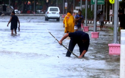 <p><strong>CARINA IMPACT.</strong> Security personnel help remove clogged waterways amid flooding brought about by torrential rain near the Senate premises along W. Diokno Boulevard in Pasay City on Wednesday (July 24, 2024). The United States, Australia, Chinese, and Canadian Embassies in Manila have offered assistance as Super Typhoon Carina and enhanced southwest monsoon battered the Philippines. <em>(PNA photo by Avito Dalan)</em></p>