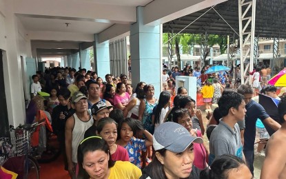 <p><strong>RELIEF OPS</strong>. Flood victims line up for the hot meal and bottled water being provided by the Office of the Speaker and Tingog Party-list at the Malanday Elementary School in Marikina City on Wednesday (July 24, 2024). The Offices of the House Speaker and Tingog Party-list has launched relief operations for thousands of flood victims in Metro Manila, as well as in Northern and Central Luzon.<em> (Photo courtesy of Tingog)</em></p>