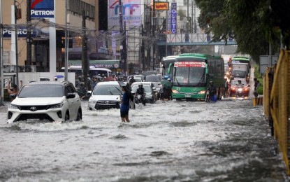 <p><strong>WATER WORLD.</strong> Motorists brave floods along Quezon Avenue and corner BMA Avenue in Quezon City as the southwest monsoon enhanced by Typhoon Carina drenched the metropolis on July 24, 2024. According to the Metropolitan Manila Development Authority, the massive flooding, exacerbated by improper waste disposal, emphasizes the need to rehabilitate the already antiquated drainage system of Metro Manila. <em>(PNA file photo by Yancy Lim)</em></p>