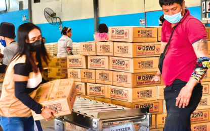 <p><strong>RELIEF OPS.</strong> Personnel of the Department of Social Welfare and Development (DSWD) prepare family food packs (FFPs) for victims of Super Typhoon Carina and enhanced southwest monsoon or habagat in this undated photo. DSWD Secretary Rex Gatchalian said the agency is ready to replenish FFPs for local government units hit heavy rains and floods.<em> (Photo courtesy of DSWD)</em></p>