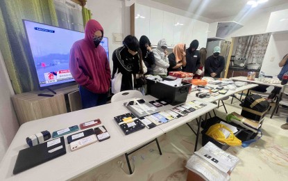 <p><strong>NABBED.</strong> Members of the PNP ACG arrest nine persons allegedly involved in voice phishing scam in Cavite province on Wednesday (July 24, 2024). The ACG said the suspects defrauded unsuspecting victims of around PHP40 milliion. <em>(Photo courtesy of PNP-ACG)</em></p>