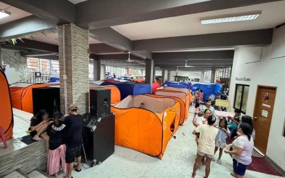 <p><strong>SHELTER</strong>. Evacuees take refuge at an evacuation center in Quezon City as Typhoon Carina and the enhanced southwest monsoon or habagat trigger heavy rains and massive flooding across the country. President Ferdinand R. Marcos Jr. directed the Department of Health to ensure the health care of evacuees during a situation briefing on Thursday (July 25, 2024). <em>(Photo from Quezon City Government Facebook)</em></p>