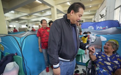 <p><strong>RELIEF GOODS</strong>. House Speaker Martin Romualdez talks with one of the elderly evacuees at the San Juan City Gymnasium on Thursday (July 25, 2024). Romualdez led the distribution of relief packs and financial aid to around 3,000 families who evacuated amid the onslaught of Super Typhon Carina and the enhanced southwest monsoon. <em>(Photo courtesy of Romualdez's office)</em></p>