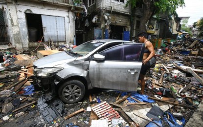 <p><strong>RUINS.</strong> A resident checks his car in the aftermath of the devastation brought by bad weather along West Riverside St., Del Monte, Quezon City on July 26, 2024. The NDRRMC on Tuesday (July 30) said the death toll from the effects of heavy monsoon rains induced by Typhoon Carina last week has climbed to 39. <em>(PNA photo by Joan Bondoc)</em></p>