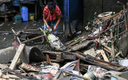 <p><strong>DONATION</strong>. A woman cleans up as flood subsides in Del Monte, Quezon City on July 26, 2024, following the onslaught of the southwest monsoon and Super Typhoon Carina. The Armed Forces of the Philippines said the military is donating the equivalent of one meal from their subsistence allowance to victims. <em>(PNA photo by Joan Bondoc)</em></p>