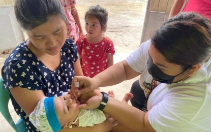 <p><strong>IMMUNIZATION.</strong> An infant is being administered a bivalent oral polio vaccine in Bacolod City in this undated photo. The Department of Health 6 (Western Visayas) said 387,557 children below 5 years old in the region were vaccinated against polio from March to July. <em>(Photo courtesy of Bacolod City Health Office)</em></p>