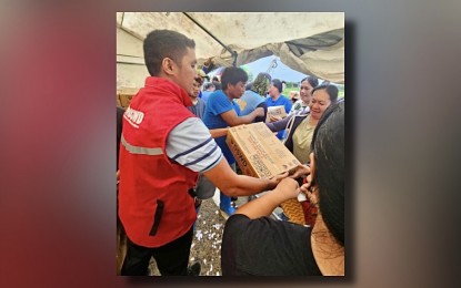 <p><strong>RELIEF OPERATIONS</strong>. Department of Social Welfare and Development staff distribute family food packs to families affected by the Super Typhoon Carina-enhanced southwest monsoon in Narvacan, Ilocos Sur in this undated photo. The Ilocos Region office has already distributed PHP12 million worth of food and non-food items as relief packs as of July 26. <em>(Photo courtesy DSWD-Ilocos Region)</em></p>