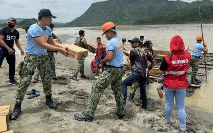 <p><strong>IMMEDIATE HELP.</strong> Family food packs reach isolated Barangay Mabungtot in Langiden, Abra on Sunday (July 27, 2024), intended for victims of the past week’s inclement weather. The distribution was led by the Department of Social Welfare and Development’s Angels in Red Vests, police, military and firefighters. <em>(Photo courtesy of DSWD)</em></p>