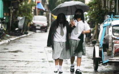 <p><strong>PROTECTED.</strong> Two learners of Parklane Senior High School in General Trias City, Cavite share an umbrella on their way home on Monday (July 29, 2024). The southwest monsoon (habagat) will continue to dampen Luzon on Tuesday (July 30), the weather bureau said. <em>(PNA photo by Avito Dalan)</em></p>