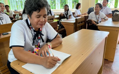 <p><strong>PROUD STUDENT</strong>. Grade 12 student Rowena Taboso, a 52-year-old grandmother, is among the thousands of learners who attended the first day of classes at the Northern Tacloban City High School on Monday (July 29, 2024). Studying under the Alternative Learning System program, most of her classmates are mothers. <em>(PNA photo by Sarwell Meniano)</em></p>