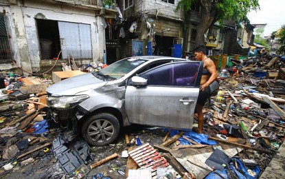 <p><strong>RUINS.</strong> A resident checks his car amid the devastation in West Riverside Street, Del Monte, Quezon City on Friday (July 26, 2024). Post-habagat (monsoon rains) and Typhoon Carina, the community started the arduous tasks of cleaning, repairing homes and rebuilding lives. <em>(PNA photo by Joan Bondoc)</em></p>