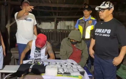 <p><strong>DRUG STING</strong>. Authorities conduct an inventory of illegal drugs worth PHP10.4 million seized from an elderly male suspect (seated, right) during a sting operation in Barangay Mactan, Lapu-Lapu City, Cebu on Monday night (July 29, 2024). The 60-year-old Cebu City resident allegedly transacted with a poseur buyer from the Lapu-Lapu City Police Office intelligence unit. <em>(Contributed photo)</em></p>