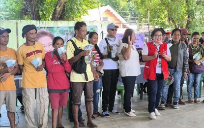 <p><strong>PAYOUT</strong>. Antique Governor Rhodora Cadiao (in red vest) joins the beneficiaries of the Risk Resiliency Program in Sibalom town during the payout of wages at the Sibalom gymnasium on Tuesday (July 30, 2024). Department of Social Welfare and Development Project Development Officer II and RRP in-charge Armil Gayorgor said in an interview that the payout of PHP20.57 million to 2,289 beneficiaries was completed. <em>(Photo courtesy of DSWD-Antique)</em></p>