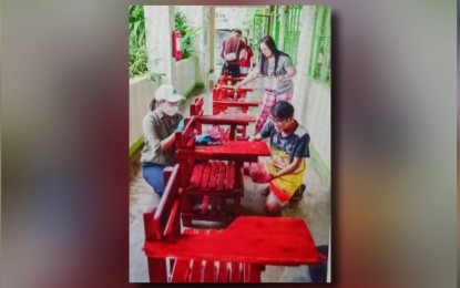 <p><strong>'BAYANIHAN'</strong>. La Union Governor Raphaelle Veronica Ortega-David (left) joins the Brigada Eskwela in a school in San Fernando City, La Union in this undated photo. The provincial government has donated PHP18.9 million cash and worth of workbooks to 453 public schools in the province for school year 2024-2025 that started on Monday (July 29, 2024). <em>(Photo courtesy of La Union provincial government)</em></p>