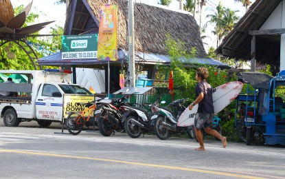 <p><strong>VITAL FACILITY.</strong> A surfer walks past the parked motorcycles at the Cloud 9 surfing spot in General Luna, Siargao Island, Surigao del Norte. A first aid facility is set to be put up this year in the town to enhance the safety of local and foreign tourists. <em>(PNA file photo by Alexander Lopez)</em></p>
<p> </p>