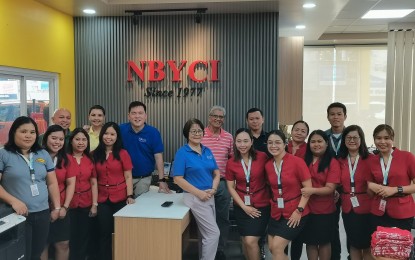 <p><strong>CLIENT SATISFACTIO</strong>N. Danford Sy (in blue shirt, back row) president of New Bian Yek Commercial Inc., with his employees, foresees an incursion of motorists with the creation of the Negros Island Region. The company has upgraded its services to boost consumer confidence with a growing economy in Dumaguete City, Negros Oriental.<em> (PNA photo by Mary Judaline Flores Partlow)</em></p>