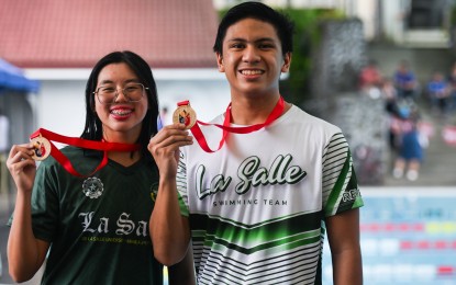 <p><strong>CHAMPIONS.</strong> De La Salle University's Kirk Dominique Reyes (right) and Janelle Kyla Chua show their medals during the awarding ceremony of the Philippine Reserve Officers Training Corps (ROTC) Games Luzon leg swimming competition at the De La Salle University - Dasmariñas pool in Cavite on July 31, 2024. The two scooped five gold medals each in various swimming events. <em>(Photo courtesy of Philippine Sports Commission)</em></p>