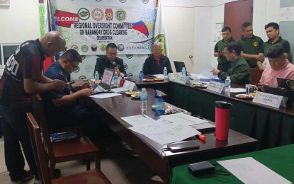 <p><strong>DRUG-CLEARED.</strong> The Regional Oversight Committee on Barangay Drug Clearing in Central Visayas, headed by Philippine Drug Enforcement Agency-7 regional director Emerson Margate (3rd from left), reviews documents from the barangays that have applied for or retained the drug-cleared status. The oversight committee announced on Thursday (Aug. 1, 2024) that 49 new barangays in Central Visayas are drug-cleared.<em> (Photo courtesy of PDEA-7 PIO)</em></p>