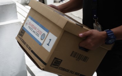 <p><strong>EVIDENCE.</strong> A box of evidence in the Bamban, Tarlac human trafficking case is carried into the hearing room of the Department of Justice in Manila on Tuesday (Aug. 6, 2024). The preliminary investigations have been concluded and all cases were deemed submitted for resolution. <em>(PNA photo by Ben Pulta)</em></p>