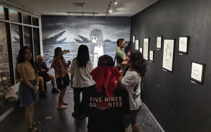 <p><strong>ART EXHIBIT.</strong> Young people visit an ongoing art show at the Arté Café Gallery in Dumaguete City, Negros Oriental province on Wednesday (Aug. 7, 2024). The city government, in collaboration with the Department of Trade and Industry, is embarking on a project that will champion the creative industry in the provincial capital. <em>(PNA photo by Mary Judaline Flores Partlow)</em></p>