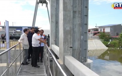 <p><strong>FLOOD CONTROL</strong>. President Ferdinand R. Marcos Jr., along with House of Representatives Speaker Martin Romualdez, Public Works Secretary Manny Bonoan, and local officials, inspects the PHP7.57-billion Integrated Disaster Risk Reduction and Climate Change Adaptation Project - Stage 1 (IDRR-CCA 1) in Masantol, Pampanga on Wednesday (Aug. 7, 2024). The project, according to the President, will benefit the towns of Macabebe, Masantol, Minalin, and Sto. Tomas. <em>(RTVM Screengrab)</em></p>