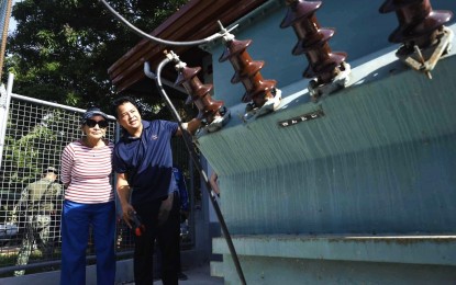 <p><strong>SWITCHING ON.</strong> Governor Gwendolyn Garcia listens as an official of the Cebu Electric Cooperative II explains the electric distribution process shortly after the switch-on ceremony on Tuesday (Aug. 6, 2024) in Malapascua Island. Garcia said the provincial government is now operating the generator sets that supply power to the island residences and establishments. <em>(Photo courtesy of Cebu Capitol PIO)</em></p>