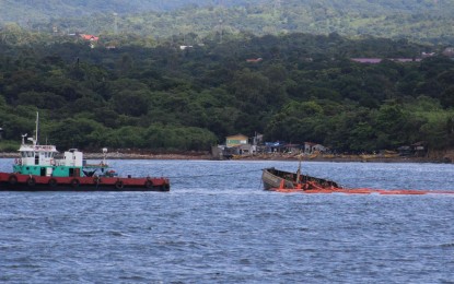 <p><strong>RECOVERY OPS.</strong> A tugboat attached to the partially afloat MTKR Jason Bradley during recovery operations on Monday (Aug. 12, 2024) in waters off Barangay Cabcaben in Mariveles, Bataan. Oil recovery operations for its cargo of 5,500 liters of oil are expected to begin once the vessel is secured in the nearest shoreline.<em> (Photo courtesy of PCG)</em></p>