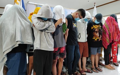 <p><strong>END OF THE LINE.</strong> Some of the 29 foreign and Filipino nationals arrested in an online scam hub raid in Kawit, Cavite are presented to the media by the National Bureau of Investigation at its Quezon City office on Tuesday (Aug. 13, 2024). Twenty-four Filipinos, three Chinese and two Malaysians were found working in four houses in Grand Centennial Homes, where they operate romance, investment, crypto and impersonation scams. <em>(Photo courtesy of NBI)</em></p>